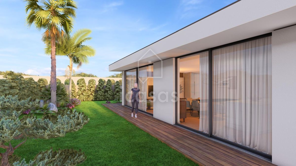 Project image: the elevation facing the garden, with the living-room openings